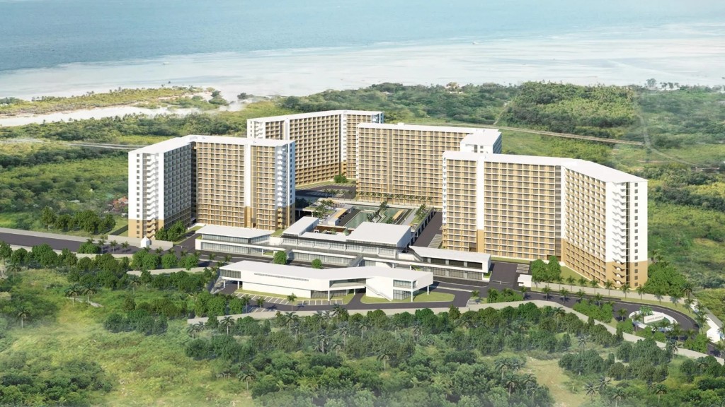 Aerial view of Saekyung Ocean Residences — four 16-storey towers around a central pool, framed by sea and greenery